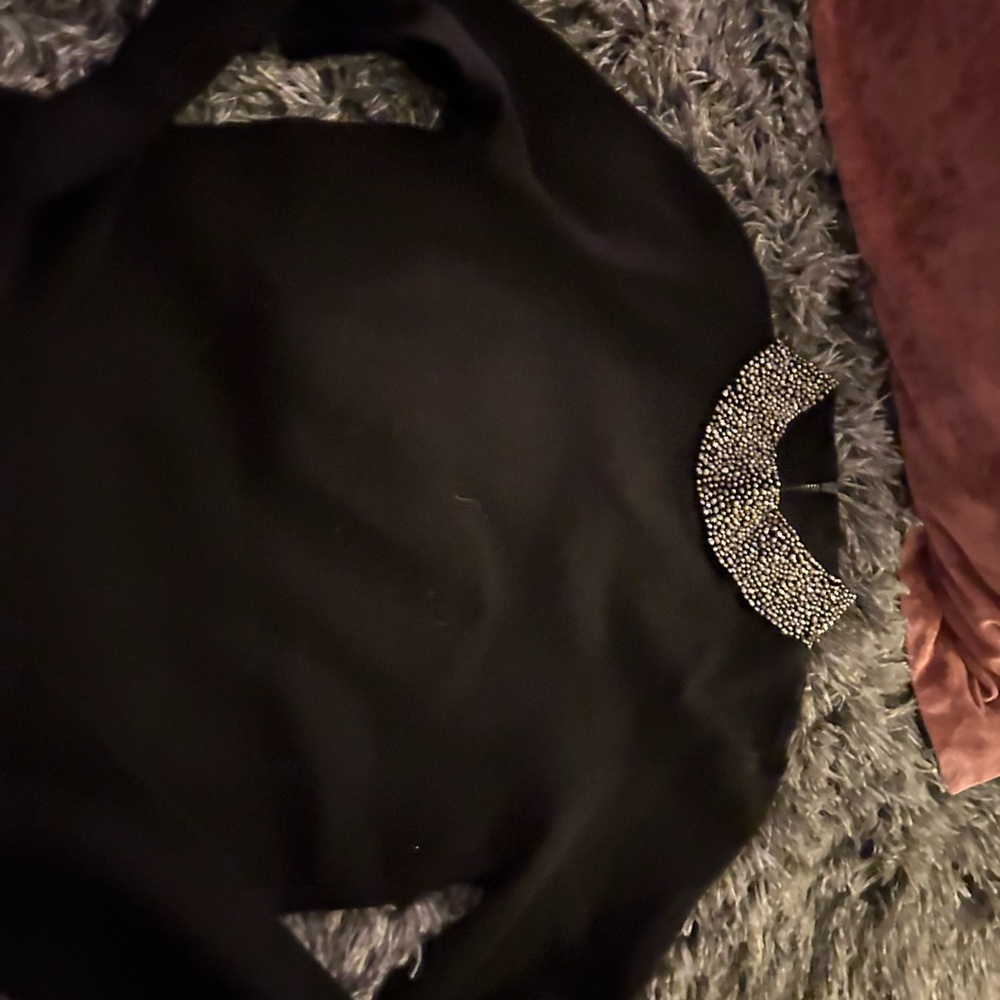 Black sweater with silver sequin neck line